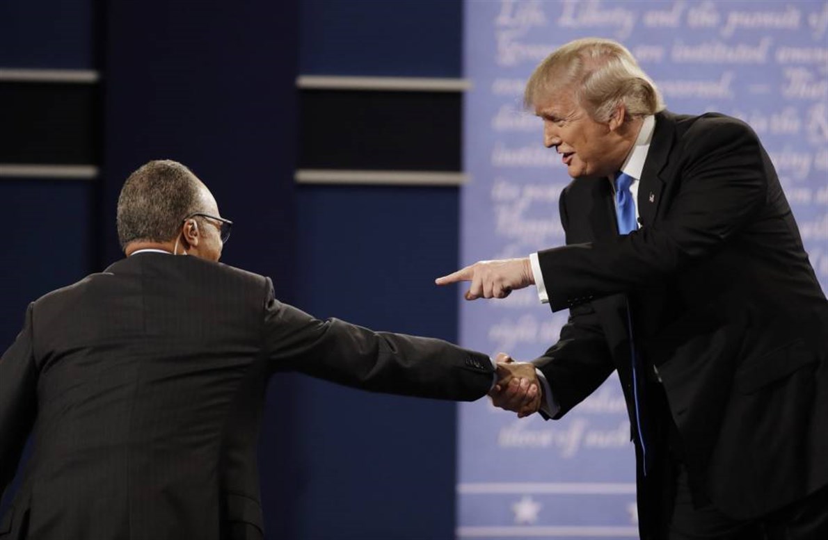 El candidato republicano, Donald Trump, saluda al moderador del debate, el periodista Lester Holt.